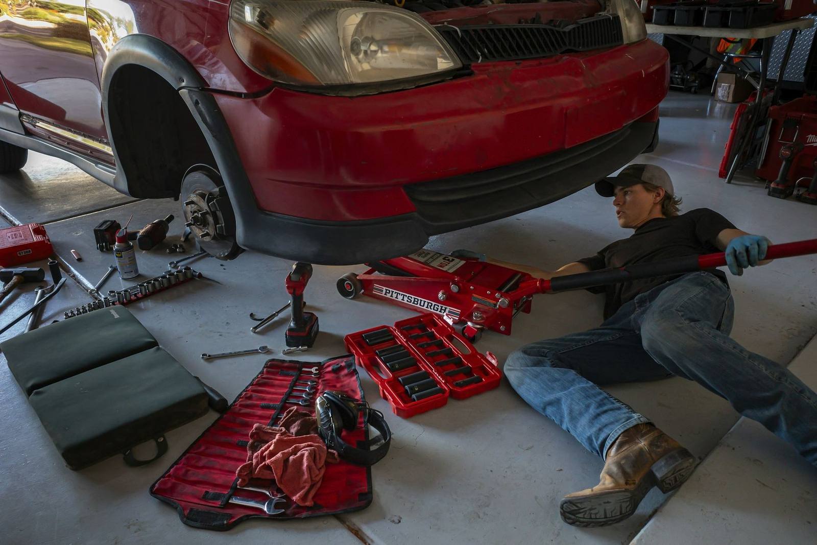 A Ninebark Motors technician working underneath a vehicle